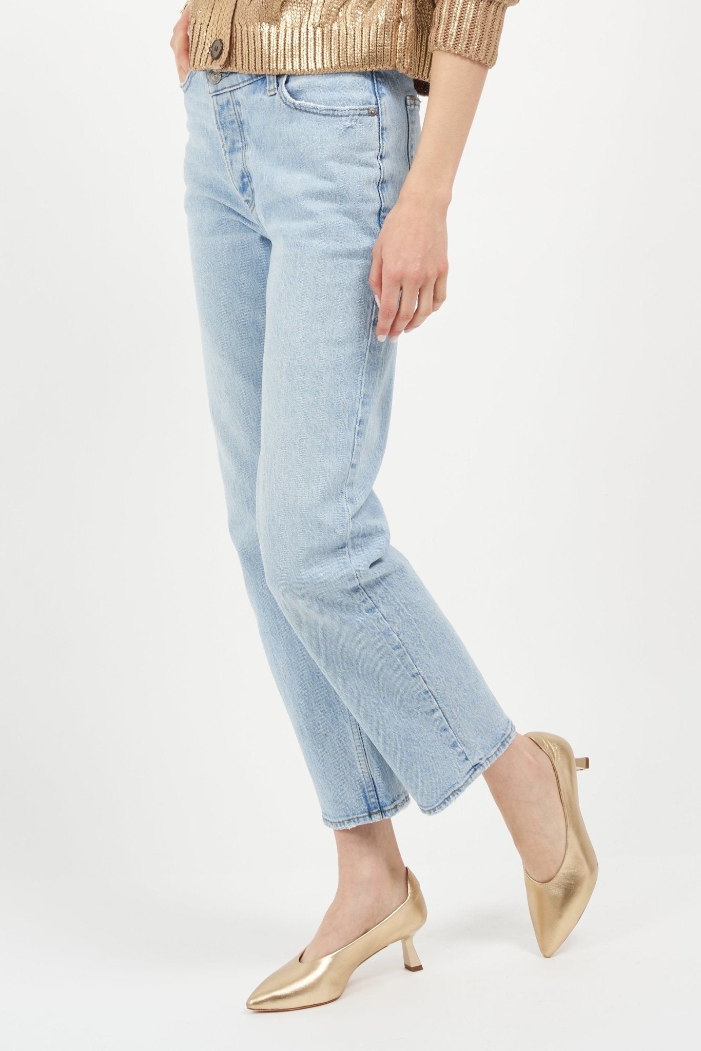 Light blue jeans worn by a person on a white background
