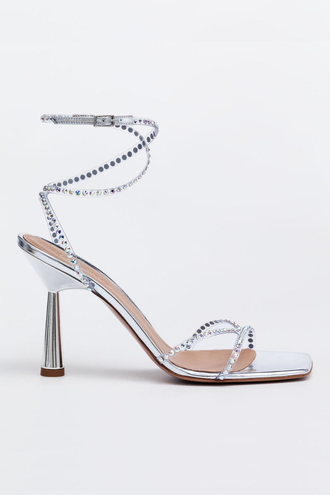 Silver high-heeled sandal with rhinestone detailing on a light gray background.