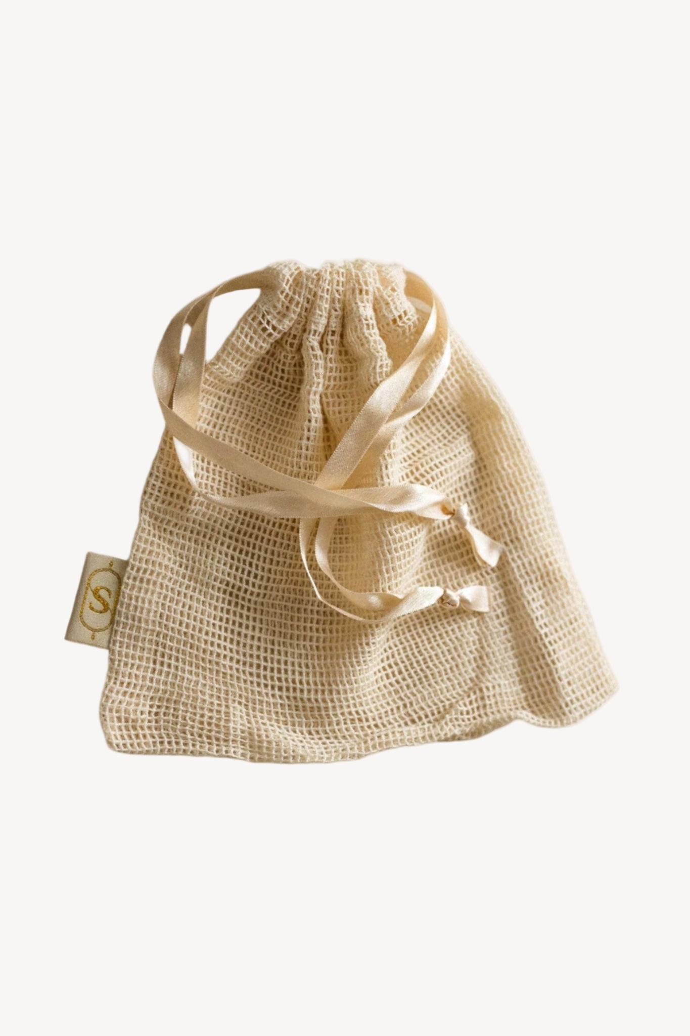 Beige drawstring bag on a white background