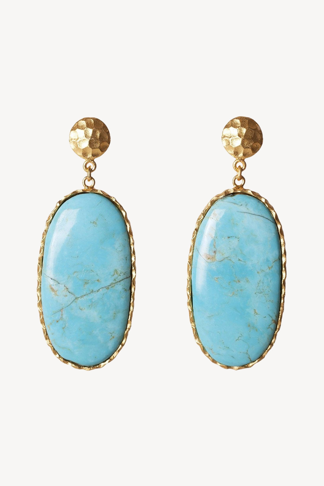 Turquoise earrings with gold frames on a white background