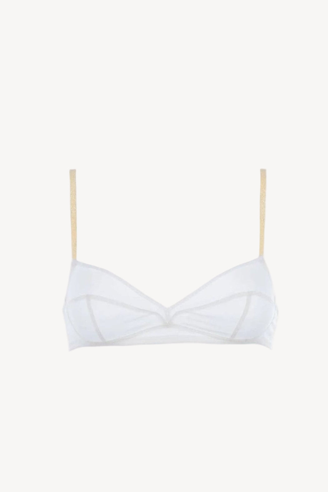 White bra with golden straps on a light beige background